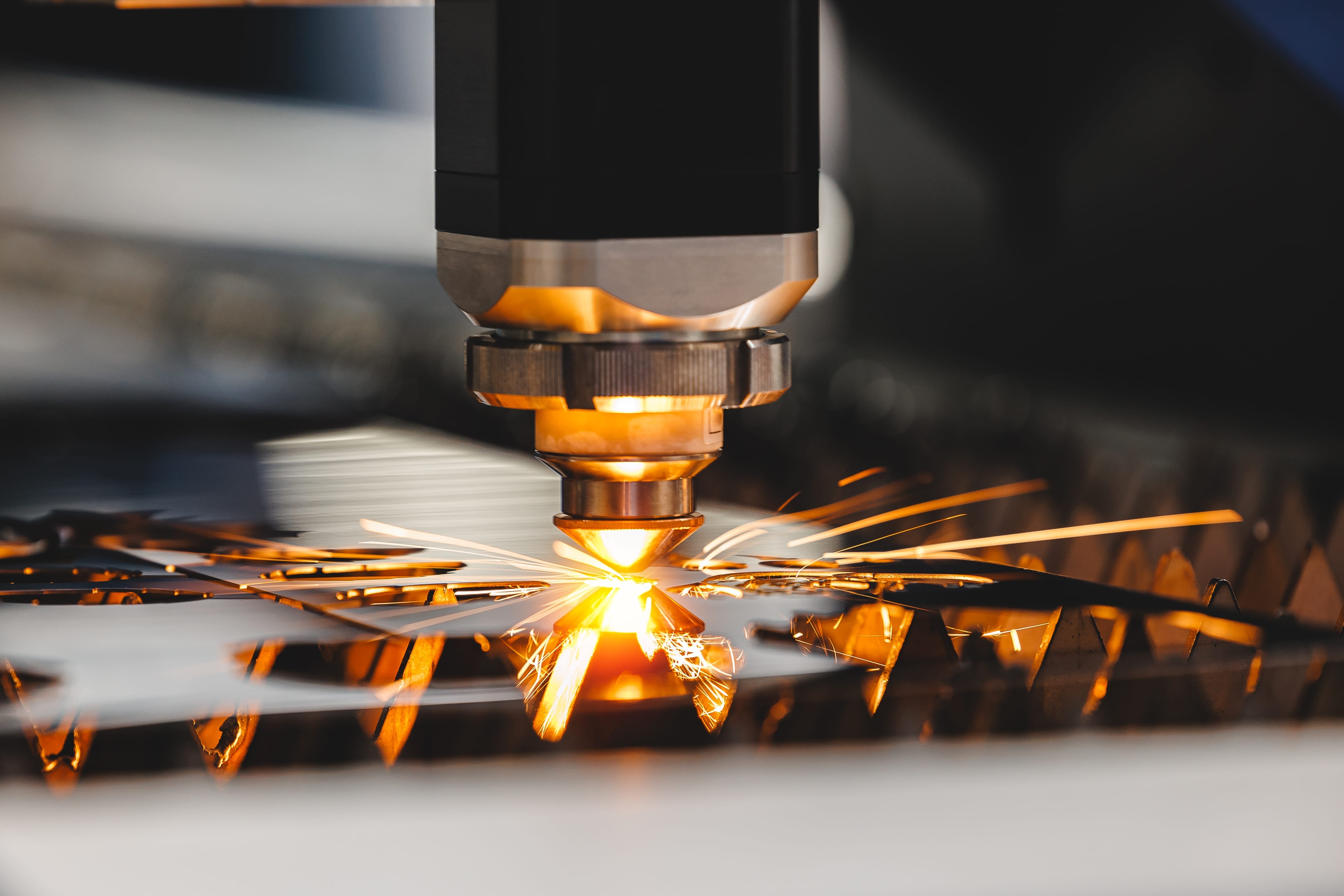 laser,cnc,cut,of,metal,with,light,spark.,industry,background