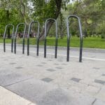 a,stainless,steel,bike,rack,in,a,public,park.