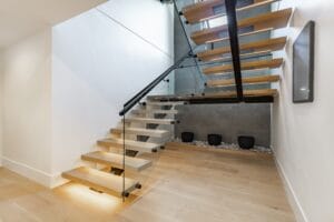 contemporary,home,interior,staircase,cantilever,steps,glass,panel,wrought,iron